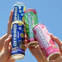 Four OxyShred Energy cans held up against a blue sky